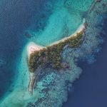 Remote small island surrounded by deep blue sea
