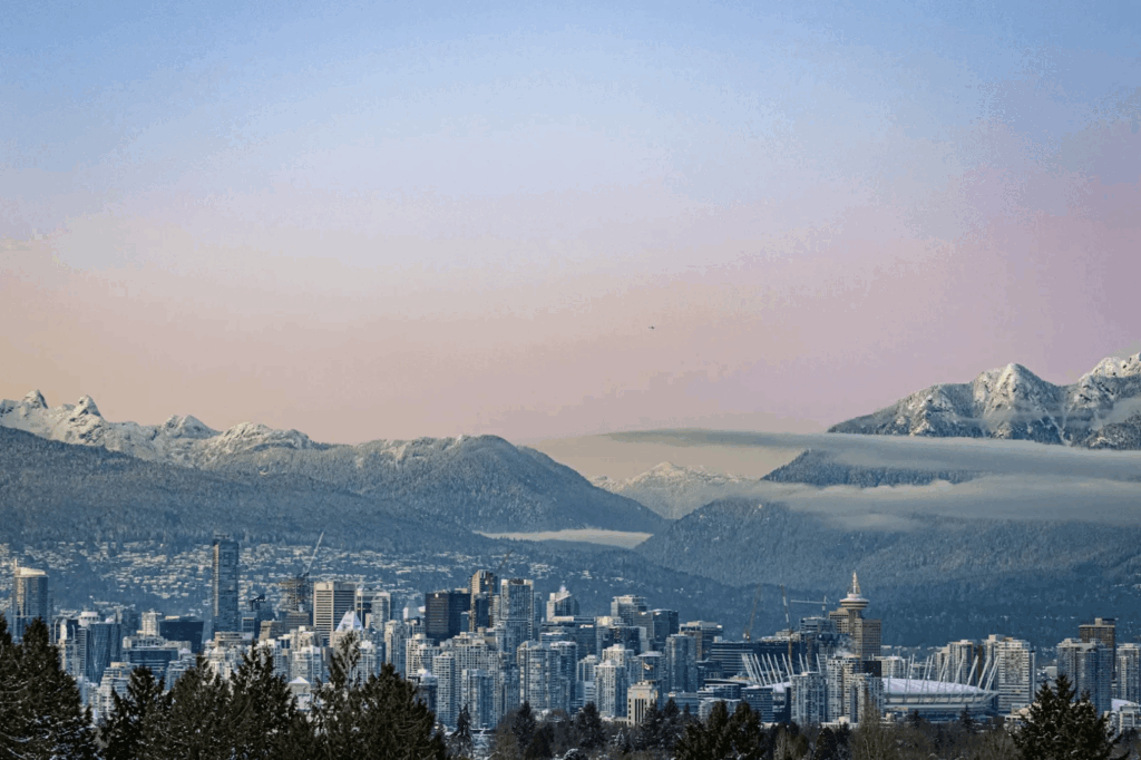 Urban Oases 2026: Explore the World’s Top Green Cities & Parks 3 Vancouver with mountains and forests in the background.