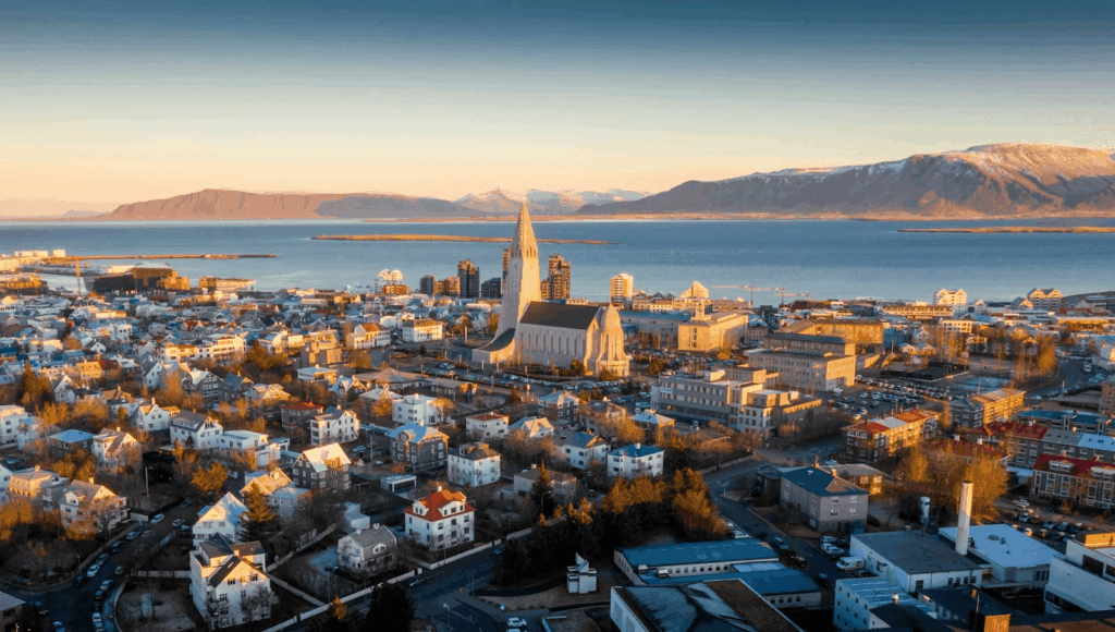 Urban Oases 2026: Explore the World’s Top Green Cities & Parks 9 Reykjavik with church, ocean, and mountains in the background.