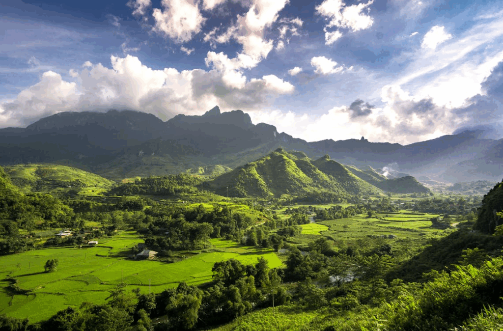 Affordable Summer Vacations: Top Budget Destinations & Tips 2 Hà Giang, Vietnam: green landscape with rolling hills and mountains in the background on a sunny day