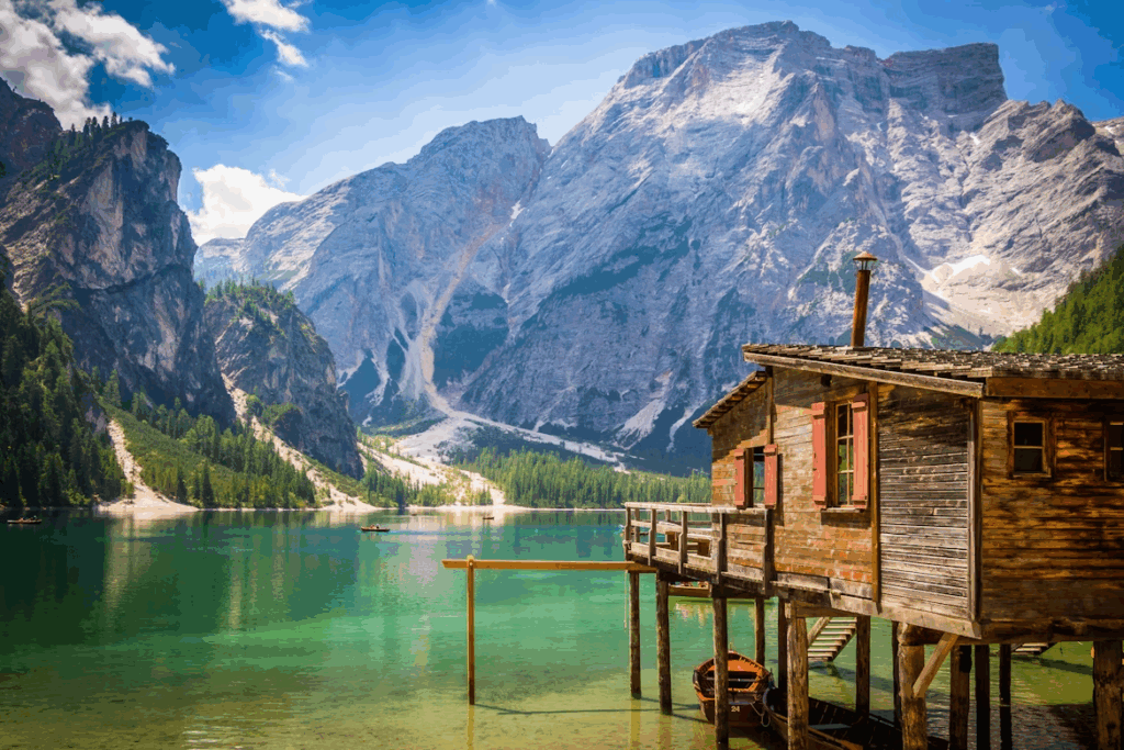What is the Best Way to Travel Through Italy? 2025 Guide 7 Brown wooden house beside body of water overlooking rocky mountain during daytime