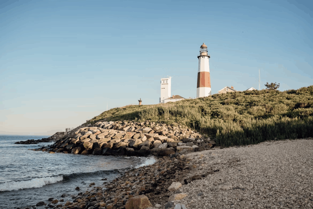 12 Stunning Photogenic Fishing Villages on the US East Coast 5 A lighthouse sitting on top of a hill next to the ocean