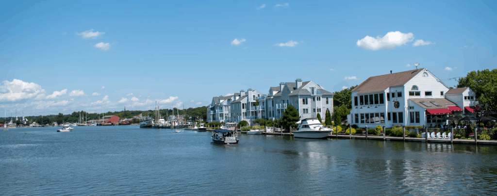 12 Stunning Photogenic Fishing Villages on the US East Coast 9 white and black boat on sea near city buildings under blue sky during daytime