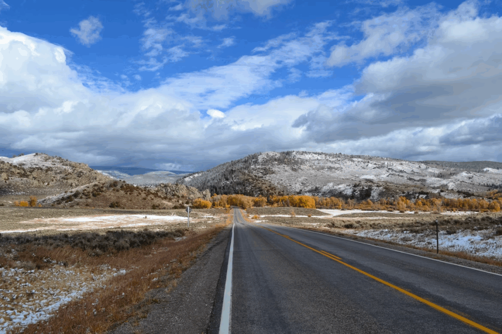 gray-concrete-road-under-blue-sky-and-white-clouds-during-daytime