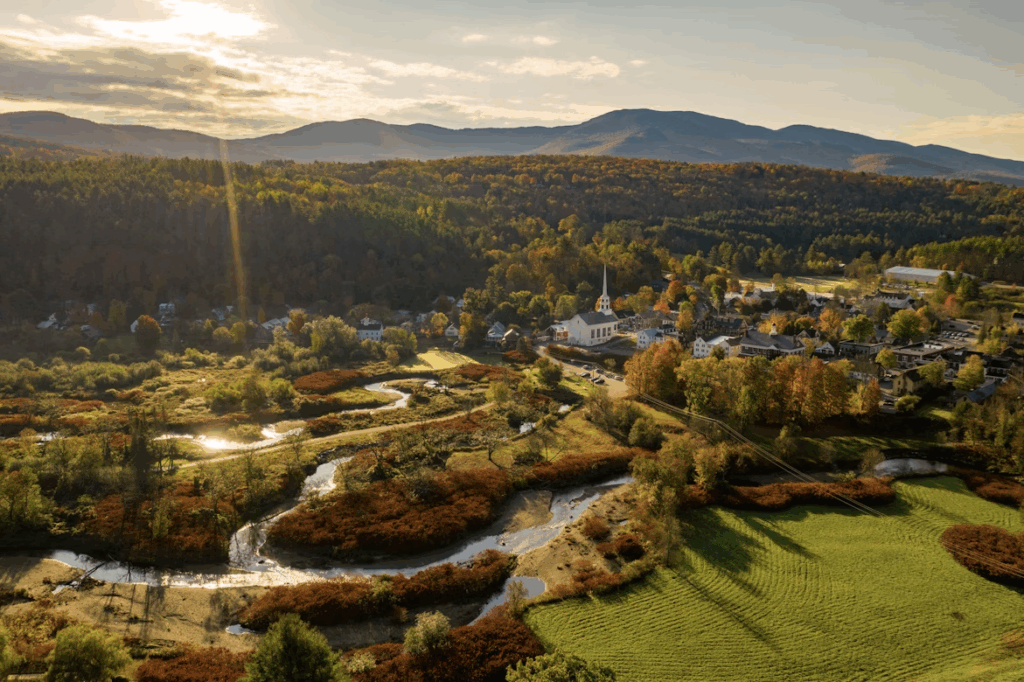 A view from above shows a small town nestled among the mountains.