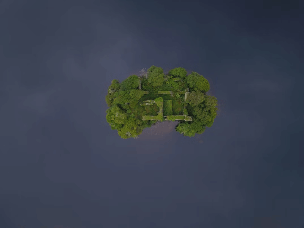 Loch an Eilein, a hidden Scottish loch surrounded by forest, with crystal-clear water reflecting the sky and nearby mountains