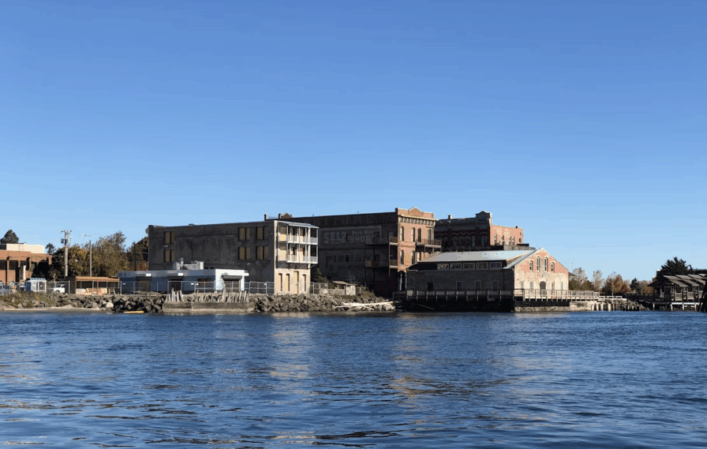 brown-concrete-building-near-body-of-water-during-daytime