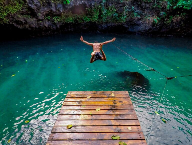 Man diving into the cave Pool in Samoa