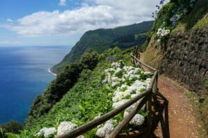 High angle view of a winding mountain road in Ponta Delgada, elevated along the scenic coastal landscape