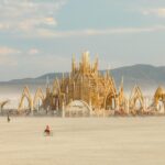 A group of festival-goers walking across a sandy desert at Burning Man